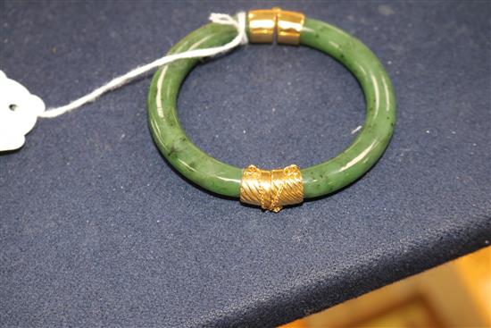 A modern jade and yellow metal-mounted bangle (unmarked) and a similar tablet ring,